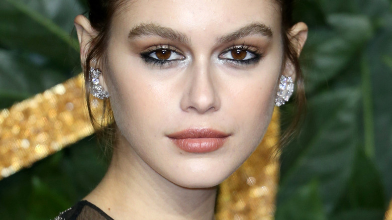 Kaia Gerber with brushed-up brows, eyeliner and diamond earrings