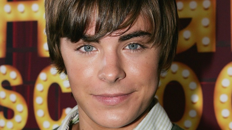 Zac Efron wears a green sweater at a "High School Musical" event
