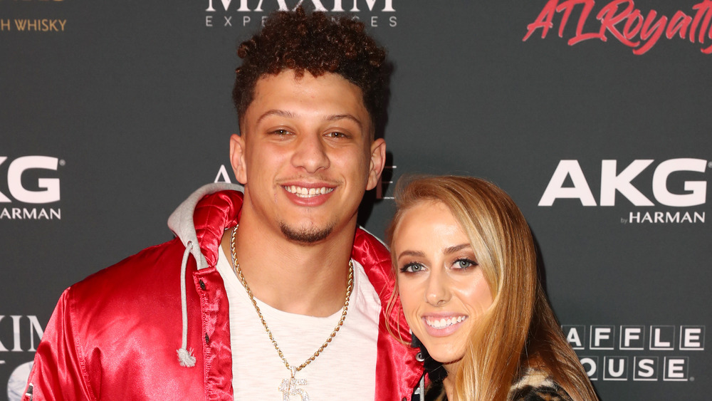 Patrick Mahomes and Brittany Matthews posing at an event