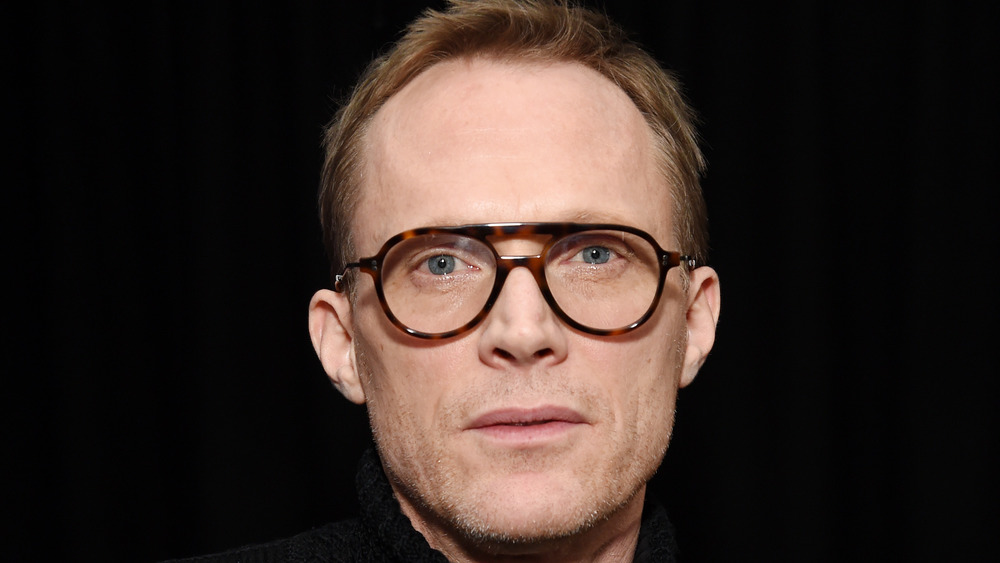 Paul Bettany wearing glasses looking directly forward