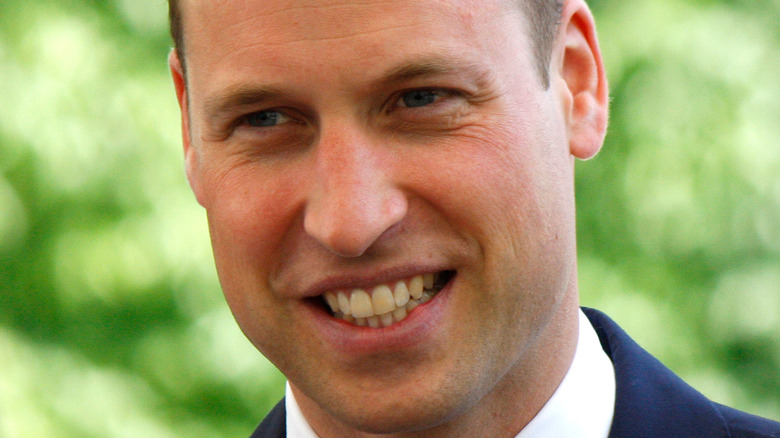Prince William smiling with his head tilted slightly