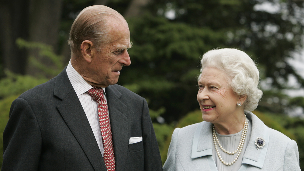 Prince Philip and Queen Elizabeth II smiling at each other