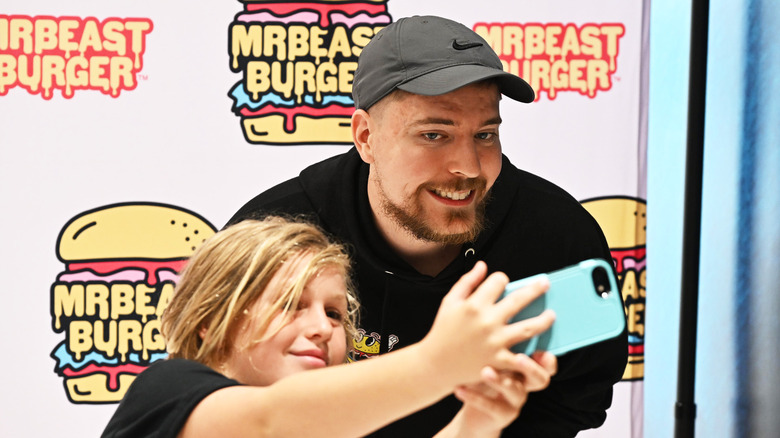 MrBeast posing with a fan.