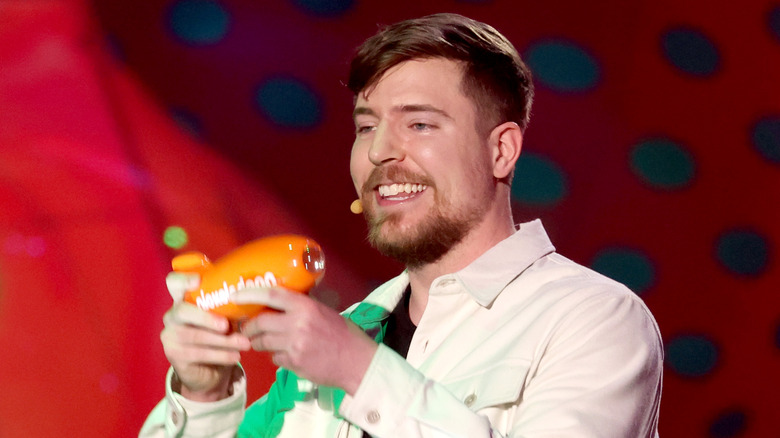 MrBeast posing with his Nickelodeon award.