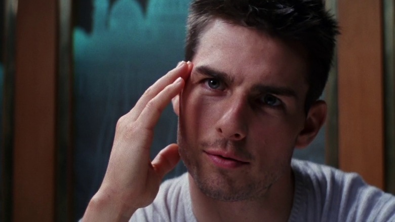Ethan Hunt holding face in white shirt