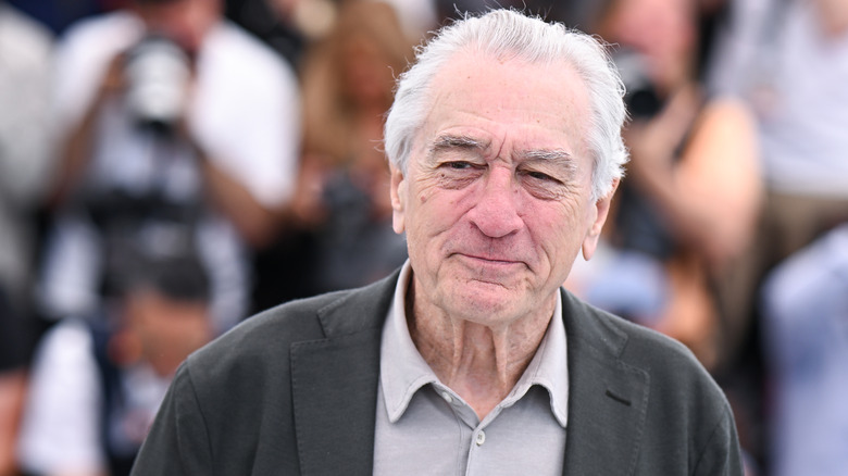 Robert De Niro standing in front of photographers