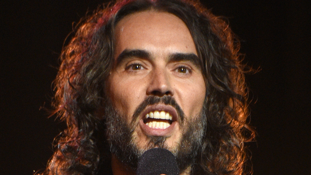 Russell Brand talking into microphone