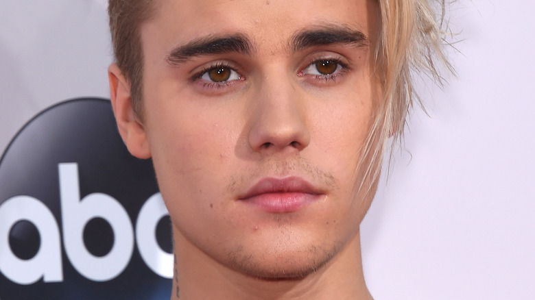 Justin Bieber looking to the side with serious expression