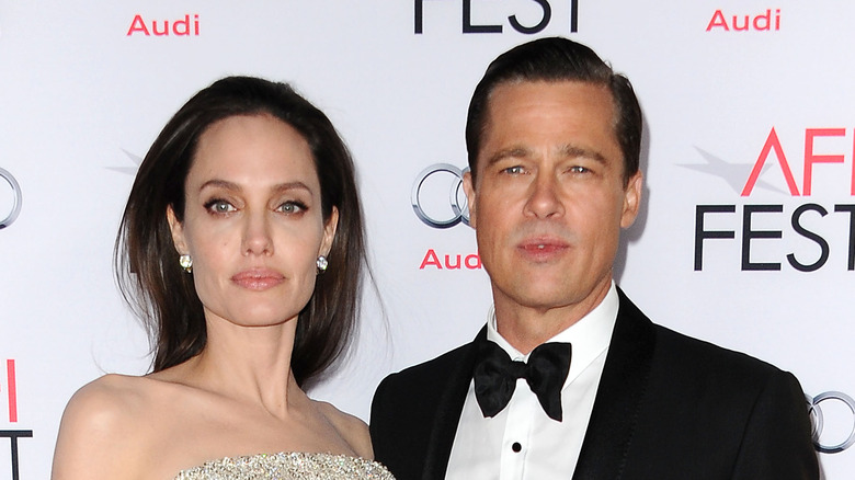  Angelina Jolie Brad Pitt looking stern on red carpet