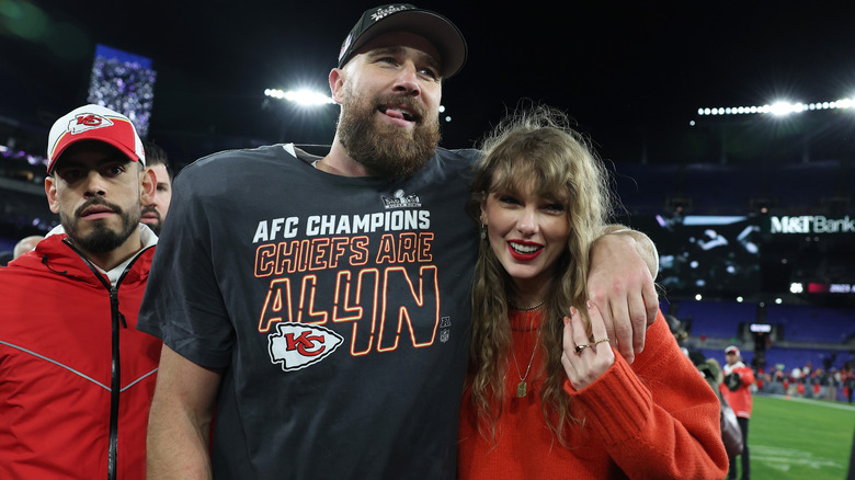 Travis Kelce with arm around Taylor Swift