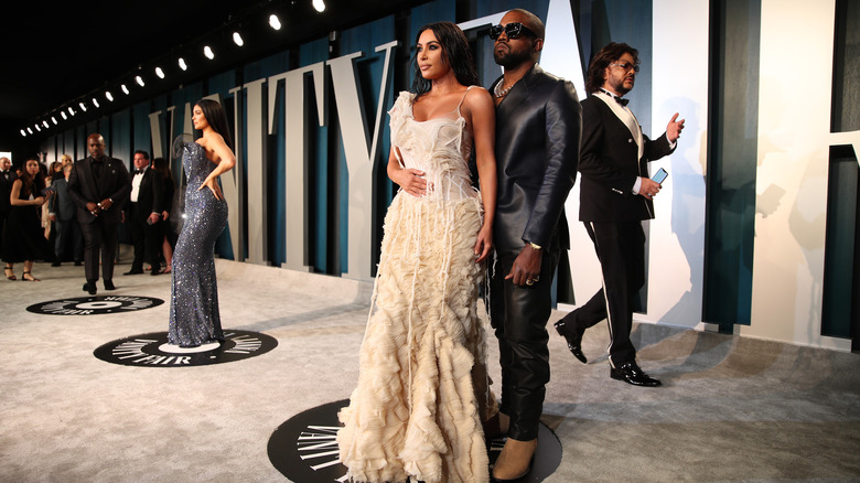 Kanye West and Kim Kardashian standing together