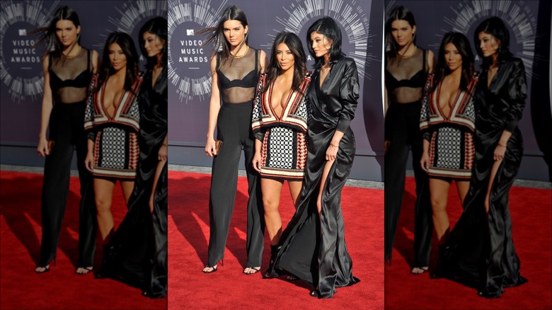 Kendall Jenner posing with sisters Kim Kardashian and Kylie Jenner