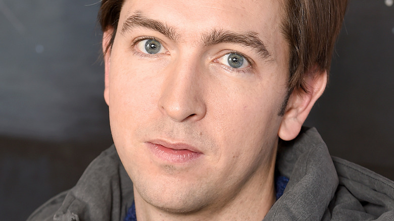 Nicholas Braun staring