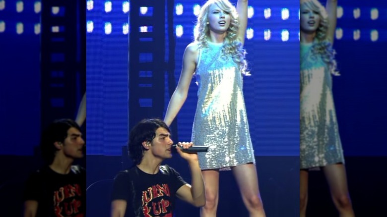 Joe Jonas and Taylor Swift performing onstage