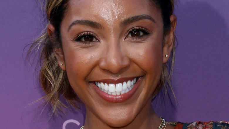 Tayshia Adams smiling at a red carpet event