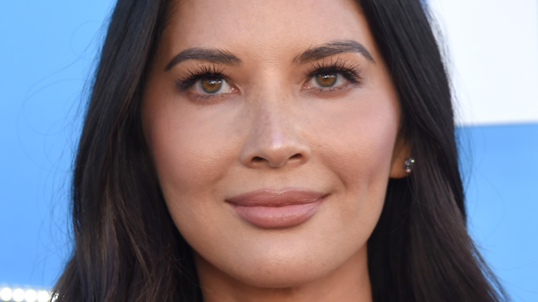 Olivia Munn smiles at a 2019 movie premiere