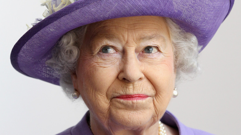 Queen Elizabeth II in purple hat