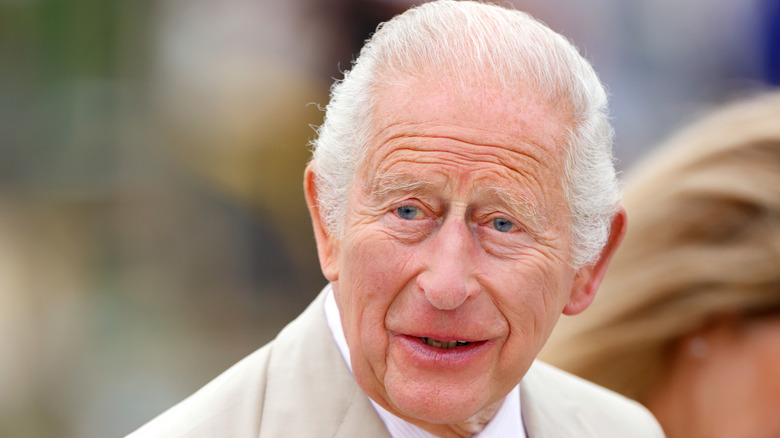 King Charles III smiling.