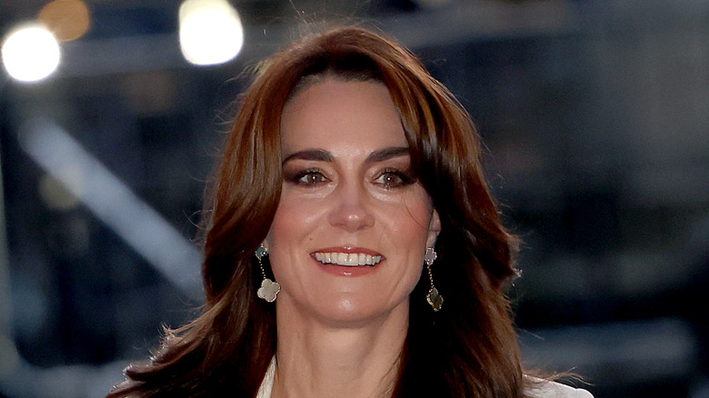 Kate Middleton smiling in close-up dangly earrings