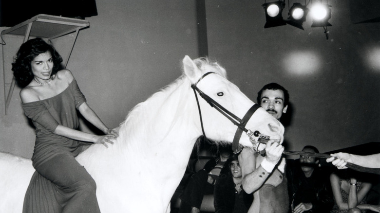 Bianca Jagger riding a white horse through Studio 54