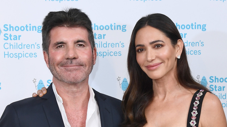 Simon Cowell and Lauren Silverman pose in 2021.