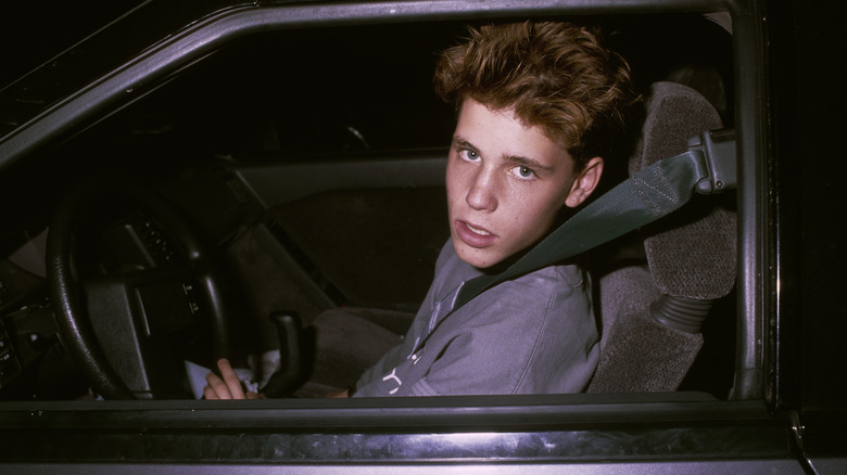 Young Corey Haim on the pilot seat of a car