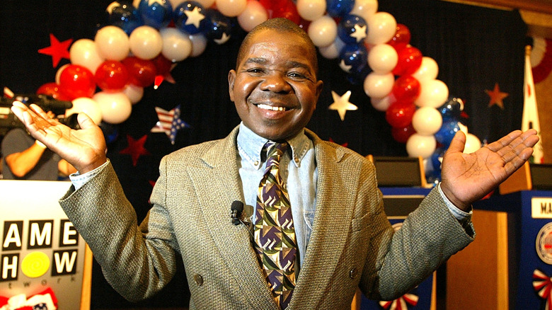 An adult Gary Coleman smiles with his hands up