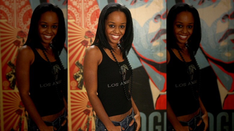 Jaimee Foxworth smiles on a black top and jeans