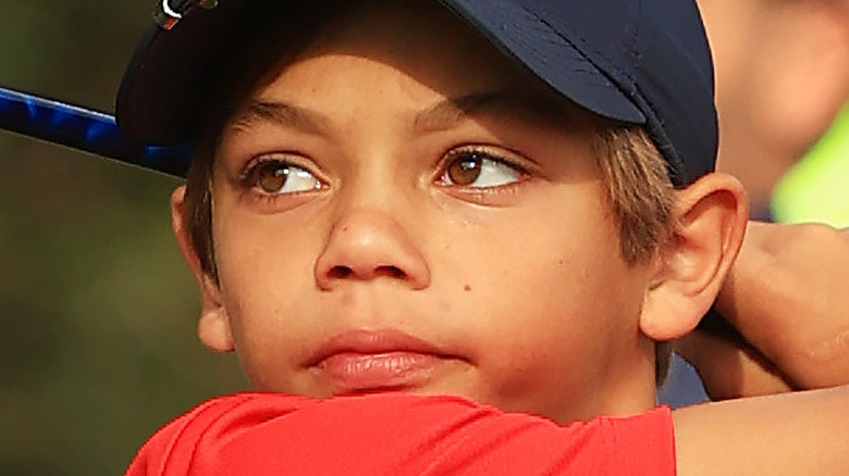 Charlie Woods swings on the golf course