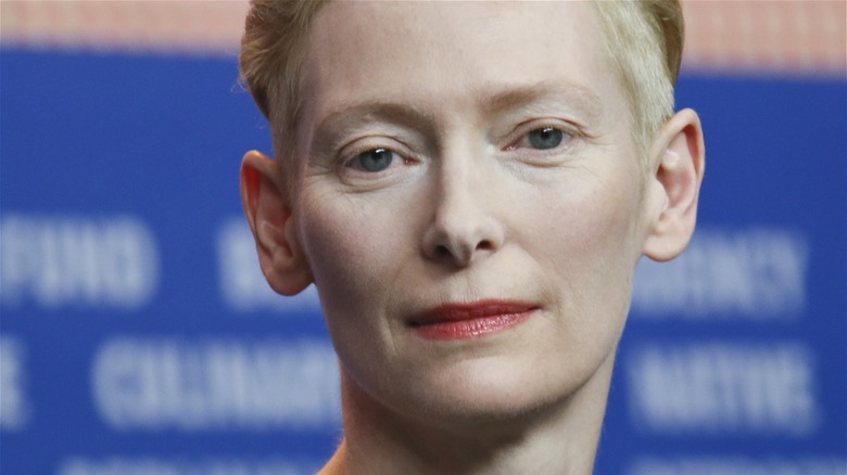 Closeup of Tilda Swinton on blue background