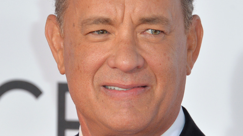 Tom Hanks smiling a little