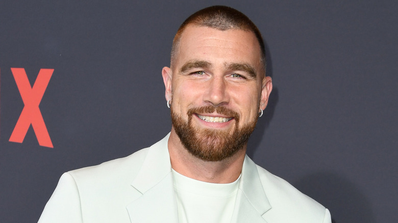 Travis Kelce smiling on the red carpet