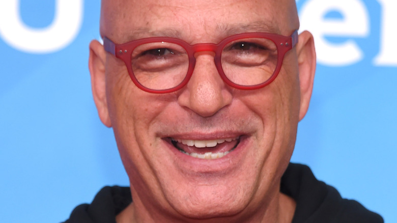 Howie Mandel smiling in glasses