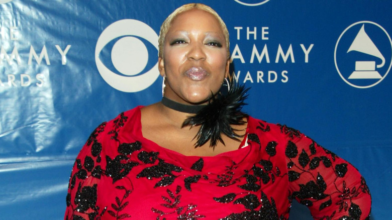 Frenchie Davis in a red-and-black top, posing at the Grammys