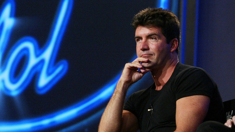 Simon Cowell in front of American Idol logo