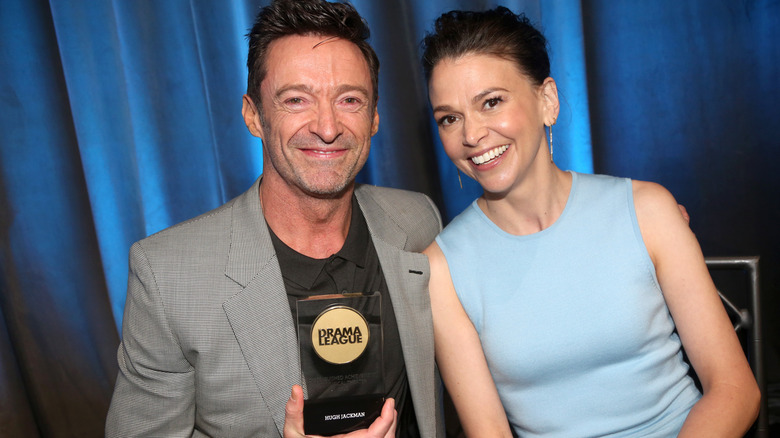 Hugh Jackman and Sutton Foster sitting and smiling