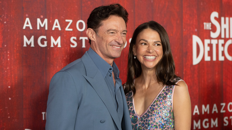 Hugh Jackman wearing a blue suit and Sutton Foster wearing a pink and silver sequined dress at the "Sheep Detectives" premiere.