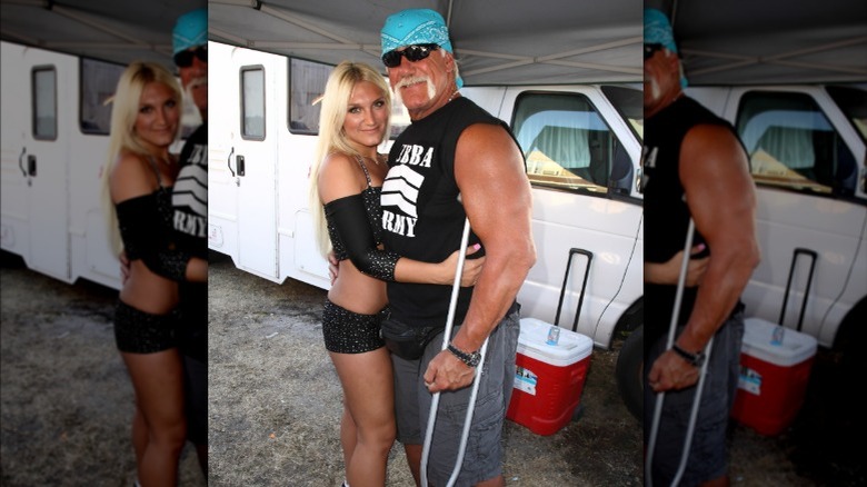 Brooke Hogan hugs Hulk Hogan while he uses crutches