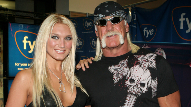 Brooke Hogan placing her hand on Hulk Hogan's shoulder