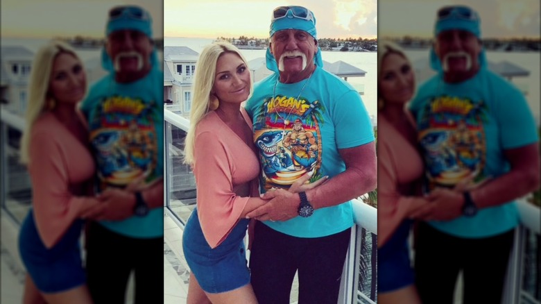 Brooke and Hulk Hogan posing together at a beach house.