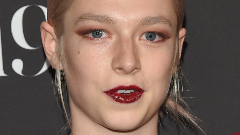 Hunter Schafer bright red lip and pink eyeshadow