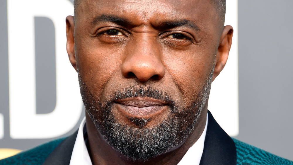 Idris Elba staring with a serious expression