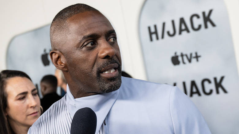 Idris Elba looks over his shoulder
