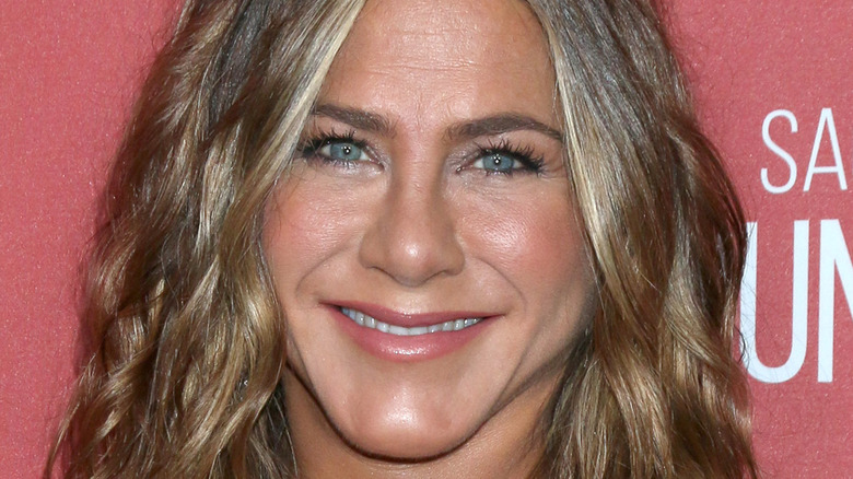 Jennifer Aniston looking at camera with wide smile 