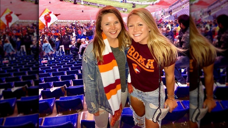 karoline Leavitt and a friend posing inside a soccer stadium