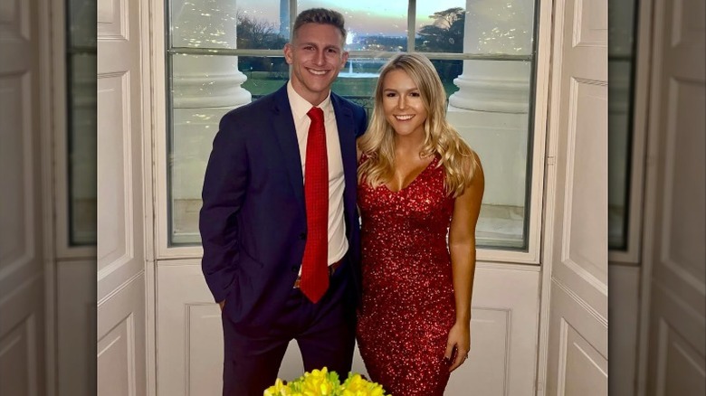 Karoline Leavitt wearing a red dress at the White House