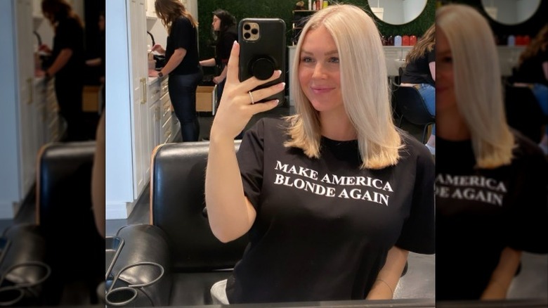Karoline Leavitt taking selfie in "Make America Blonde Again" shirt
