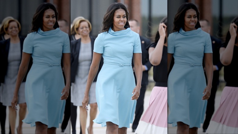 Michelle Obama walking in a powder blue dress