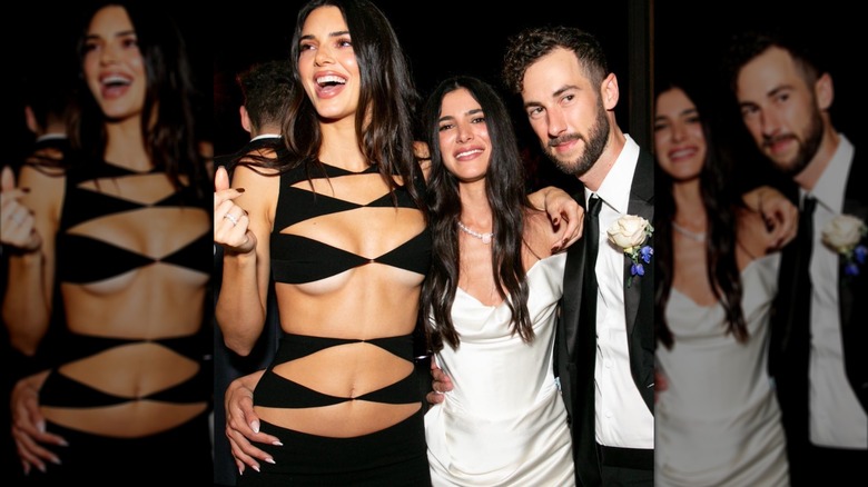 Kendall Jenner wearing skimpy dress while posing with couple