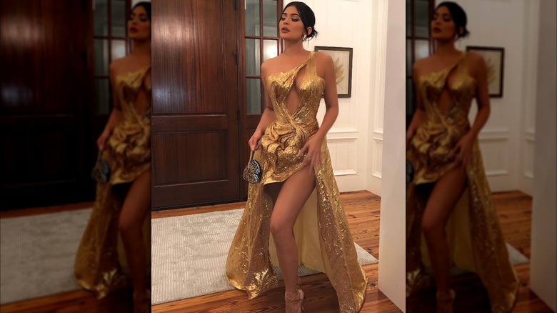 Kylie Jenner wearing a long gold dress
